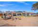 Backyard featuring an outdoor kitchen, seating around a fire pit, and a covered patio at 6995 Rogers St, Las Vegas, NV 89118