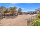 Expansive backyard with a play area, dog pen, mature trees providing ample shade at 6995 Rogers St, Las Vegas, NV 89118