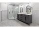 Modern bathroom with a glass-enclosed shower, dual sink vanity, and elegant mirrors providing a luxurious experience at 6995 Rogers St, Las Vegas, NV 89118