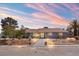 Charming single-story home showcasing professional landscaping, a welcoming walkway and mature trees at 6995 Rogers St, Las Vegas, NV 89118