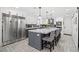 Bright, open kitchen featuring a large island with marble countertop, pendant lighting, and stainless steel appliances at 6995 Rogers St, Las Vegas, NV 89118