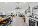 Open concept living area with island seating, herringbone flooring and a wine fridge at 6995 Rogers St, Las Vegas, NV 89118