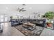 Bright living room showcasing a large sectional sofa, tile floors, and open concept floor plan at 6995 Rogers St, Las Vegas, NV 89118