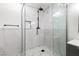 Elegant glass-enclosed shower with marble tile, a rainfall showerhead, and modern fixtures at 6995 Rogers St, Las Vegas, NV 89118