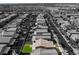A partially desaturated aerial image draws focus on a home with a green backyard at 7322 Dazzle Point St, North Las Vegas, NV 89084