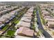 A bird's eye view showing homes with lush green lawns, a community pool, and mature trees at 7322 Dazzle Point St, North Las Vegas, NV 89084