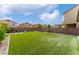 Wide open backyard featuring green space, landscaping, lounge furniture, and a playground at 7322 Dazzle Point St, North Las Vegas, NV 89084