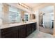 Bright bathroom with dual sinks, granite countertops, and a view of the bedroom at 7322 Dazzle Point St, North Las Vegas, NV 89084