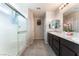 Bathroom featuring a glass-enclosed shower, tile flooring, and a dual sink vanity at 7322 Dazzle Point St, North Las Vegas, NV 89084