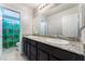 Bathroom featuring dual sinks with granite counters and a shower with themed shower curtain at 7322 Dazzle Point St, North Las Vegas, NV 89084