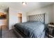 Bedroom featuring a tufted headboard, neutral color scheme and closet access at 7322 Dazzle Point St, North Las Vegas, NV 89084