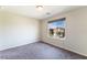 Neutral bedroom with carpet flooring and a window view of the surrounding neighborhood at 7322 Dazzle Point St, North Las Vegas, NV 89084