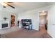 Comfortable bedroom featuring a fireplace, ceiling fan, a workspace area, and access to a walk-in closet at 7322 Dazzle Point St, North Las Vegas, NV 89084