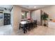 Bright dining area featuring a modern wooden table, black chairs, and large window overlooking the backyard at 7322 Dazzle Point St, North Las Vegas, NV 89084