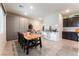 Spacious dining area with seating for eight complemented by modern storage and decor at 7322 Dazzle Point St, North Las Vegas, NV 89084