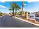 Entrance to Capella Pointe featuring palm trees and desert landscaping on a clear day at 7322 Dazzle Point St, North Las Vegas, NV 89084