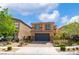 Two-story home featuring a brick-paved driveway and a dark garage door, complemented by desert landscaping at 7322 Dazzle Point St, North Las Vegas, NV 89084
