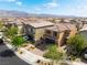A front exterior view of a modern two-story home with a well-kept lawn and professional landscaping at 7322 Dazzle Point St, North Las Vegas, NV 89084