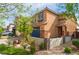 Charming two-story home with desert landscaping featuring a dark garage door and brick-paved driveway at 7322 Dazzle Point St, North Las Vegas, NV 89084