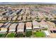 An aerial view captures homes with well-manicured lawns and driveways in a suburban neighborhood at 7322 Dazzle Point St, North Las Vegas, NV 89084