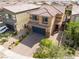 Two-story home featuring a dark blue garage, desert landscaping, and large front yard at 7322 Dazzle Point St, North Las Vegas, NV 89084