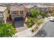 Wide open view of front exterior featuring garage, landscaping, and suburban neighborhood at 7322 Dazzle Point St, North Las Vegas, NV 89084