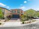 Charming two-story home featuring a dark blue garage door, landscaped front yard and modern design at 7322 Dazzle Point St, North Las Vegas, NV 89084