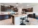 Modern kitchen with granite countertops, stainless steel appliances, and dark cabinetry at 7322 Dazzle Point St, North Las Vegas, NV 89084
