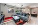 Bright living room with neutral walls, a large sectional sofa, and a modern entertainment center at 7322 Dazzle Point St, North Las Vegas, NV 89084