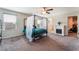 Serene main bedroom with a four-poster bed, fireplace, and ensuite bathroom access at 7322 Dazzle Point St, North Las Vegas, NV 89084