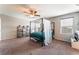 Spacious main bedroom with four-poster bed, shelves, and large window at 7322 Dazzle Point St, North Las Vegas, NV 89084