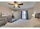 Bright bedroom with cozy bed, rustic furniture, and natural light from the window at 8000 Badura Ave # 2063, Las Vegas, NV 89113