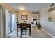 The dining area features a dining table, neutral walls, bedroom view, and access to outdoor space at 8000 Badura Ave # 2063, Las Vegas, NV 89113