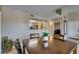 Cozy dining room with dark wood table and view to the kitchen and front door at 8000 Badura Ave # 2063, Las Vegas, NV 89113