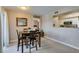 A well-lit dining room features a dining table, neutral walls, kitchen view, and natural light at 8000 Badura Ave # 2063, Las Vegas, NV 89113