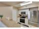 Updated kitchen with stainless steel appliances and white cabinets at 8000 Badura Ave # 2063, Las Vegas, NV 89113