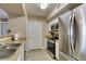 Well-lit kitchen with stainless steel refrigerator and tile floors at 8000 Badura Ave # 2063, Las Vegas, NV 89113