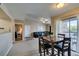 Open-concept dining and living area with access to a balcony and views of the neighborhood at 8000 Badura Ave # 2063, Las Vegas, NV 89113