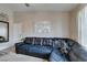 A contemporary living room boasts a black leather sofa, neutral walls, and a modern art piece at 8000 Badura Ave # 2063, Las Vegas, NV 89113