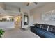 Bright living room featuring a leather sofa, neutral walls, and a view into the kitchen and bathroom at 8000 Badura Ave # 2063, Las Vegas, NV 89113