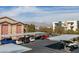 Apartment parking area with covered parking spots and views of the surrounding buildings at 8000 Badura Ave # 2063, Las Vegas, NV 89113