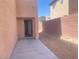 Back patio with doorway to the home in a low maintenance backyard setting at 8089 Windmill Villa St, Las Vegas, NV 89139