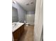Bathroom with double sink vanity, tile flooring, and bathtub and shower combo at 8089 Windmill Villa St, Las Vegas, NV 89139
