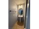 Powder room with a pedestal sink, a round mirror, and tile flooring at 8089 Windmill Villa St, Las Vegas, NV 89139
