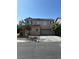 Charming two-story home featuring a neutral color palette, spacious driveway, and mature landscaping at 8089 Windmill Villa St, Las Vegas, NV 89139