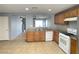 Fully equipped kitchen boasts tile floors, modern appliances and wood cabinets at 8089 Windmill Villa St, Las Vegas, NV 89139