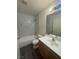 Modern bathroom featuring a tub and shower combination with marble-patterned tile at 8226 Royal Lilly Ct, Las Vegas, NV 89139