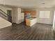 Open floor plan featuring a living room, kitchen with breakfast bar, and staircase to the second floor at 8226 Royal Lilly Ct, Las Vegas, NV 89139