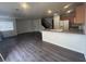 Open floor plan featuring a living room, kitchen with breakfast bar, and staircase to the second floor at 8226 Royal Lilly Ct, Las Vegas, NV 89139