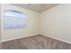 Cozy bedroom with neutral carpet and a large window providing natural light at 8467 Bismark Sapphire St, Las Vegas, NV 89139